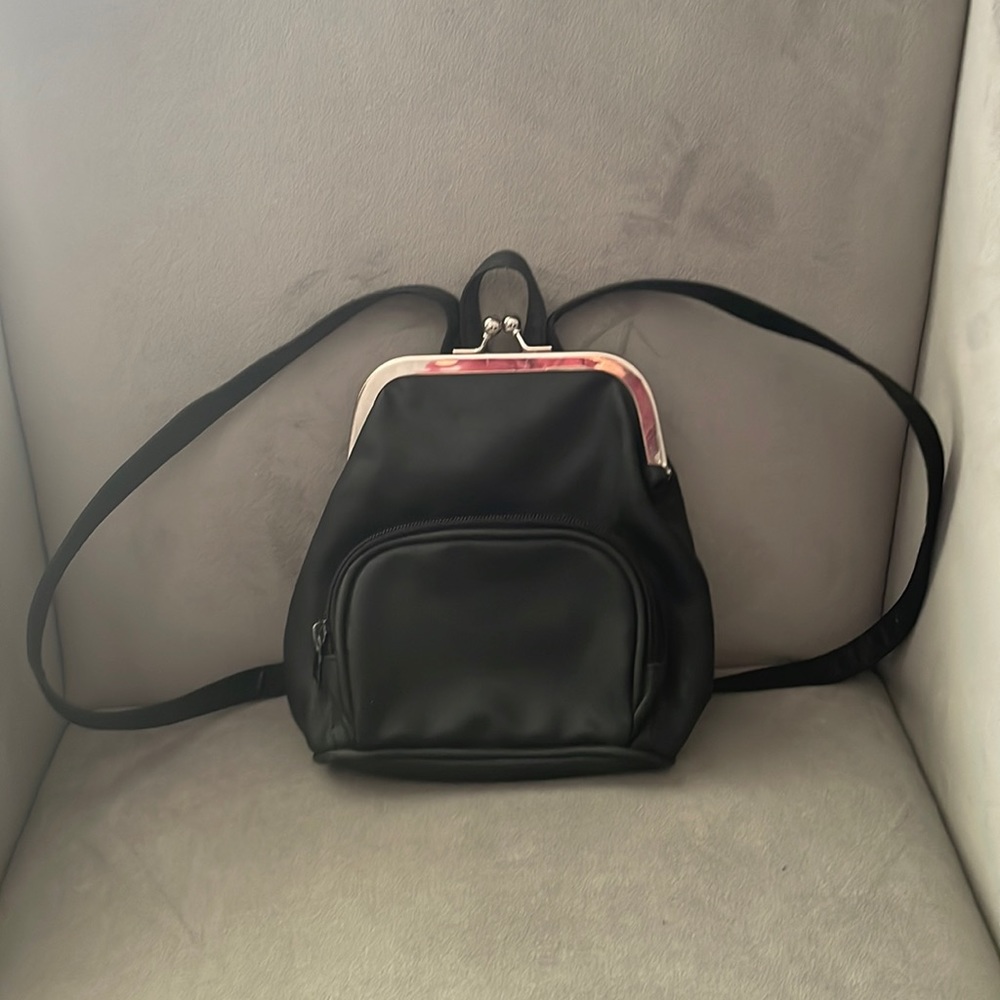 Purse backpack with vintage clip closure